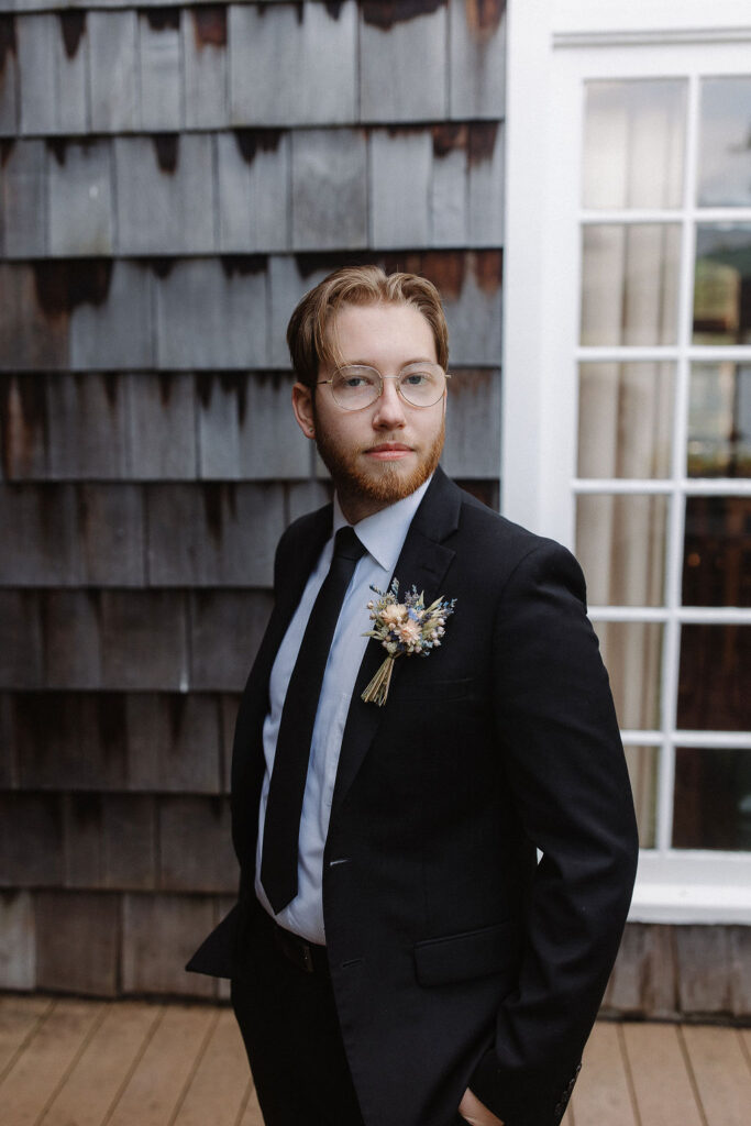 groom posing at the camera before his elopement