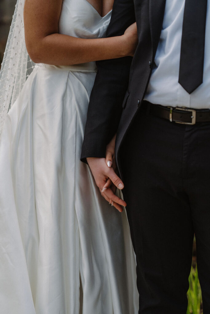 close up shot of the newly married couple holding hands at lake quinault lodge 