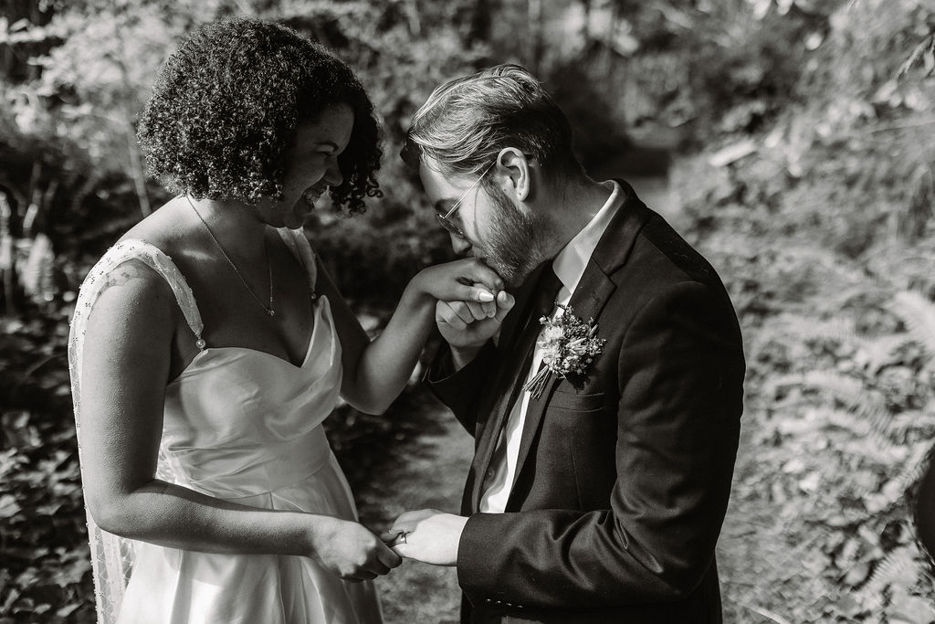 groom kissing his bride hand after their ceremony at lake quinault lodge