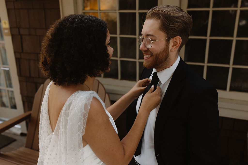 happy bride and groom fixing their clothes