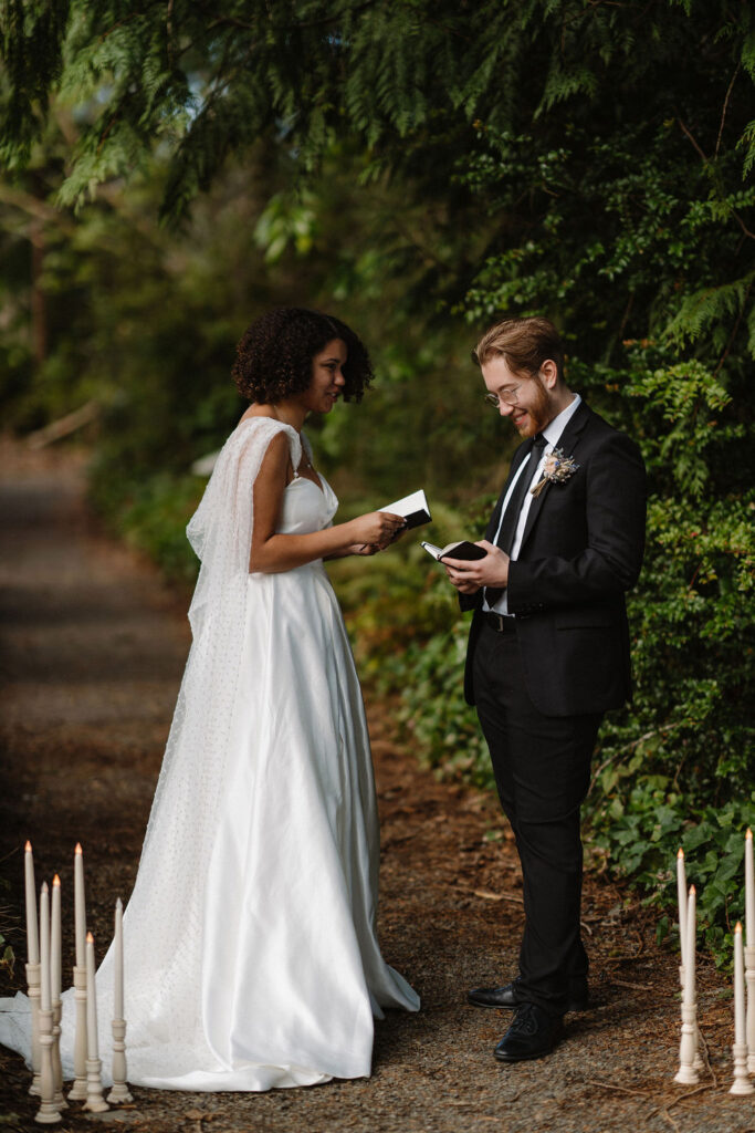 stunning couple reading their vows in the forest