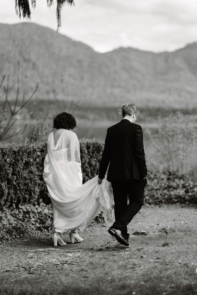 b&w photo of the bride and groom walking to their ceremony