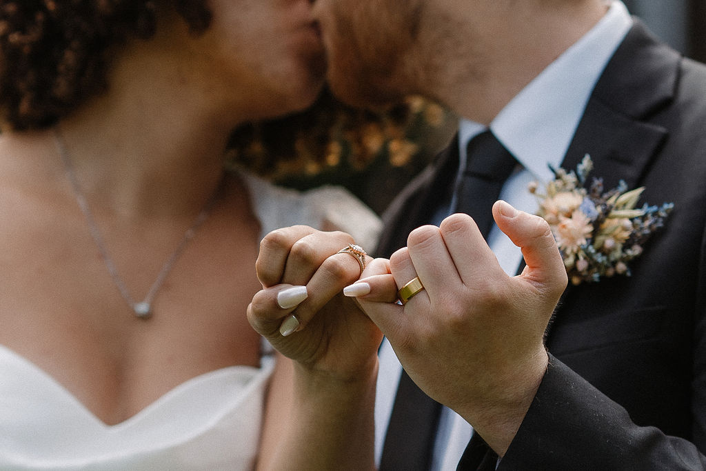 eloped couple showing their rings holding hands