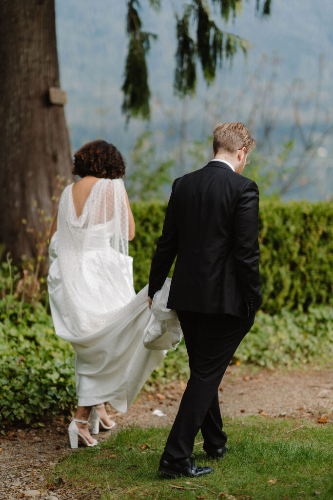 couple walking to their ceremony site at lake quinault lodge 