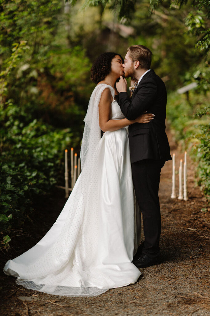 beautiful eloped couple kissing after reading their vows at lake quinault lodge 