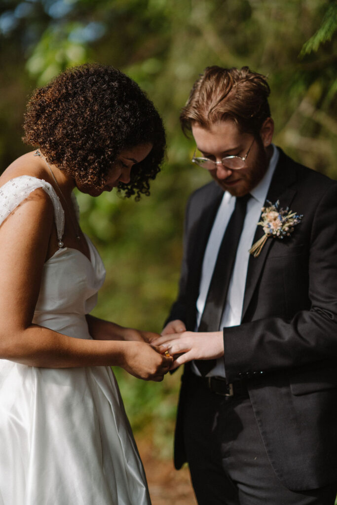 bride and groom exchanging rings at their intimate wedding at lake quinault lodge