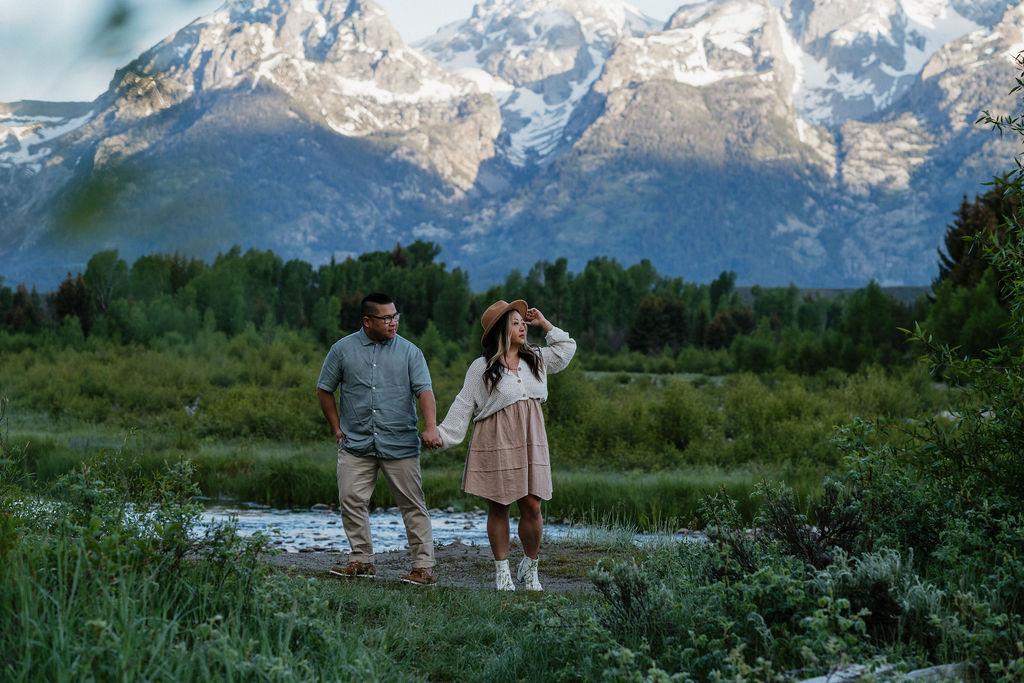 couple holding hands at their romantic boho engagement session