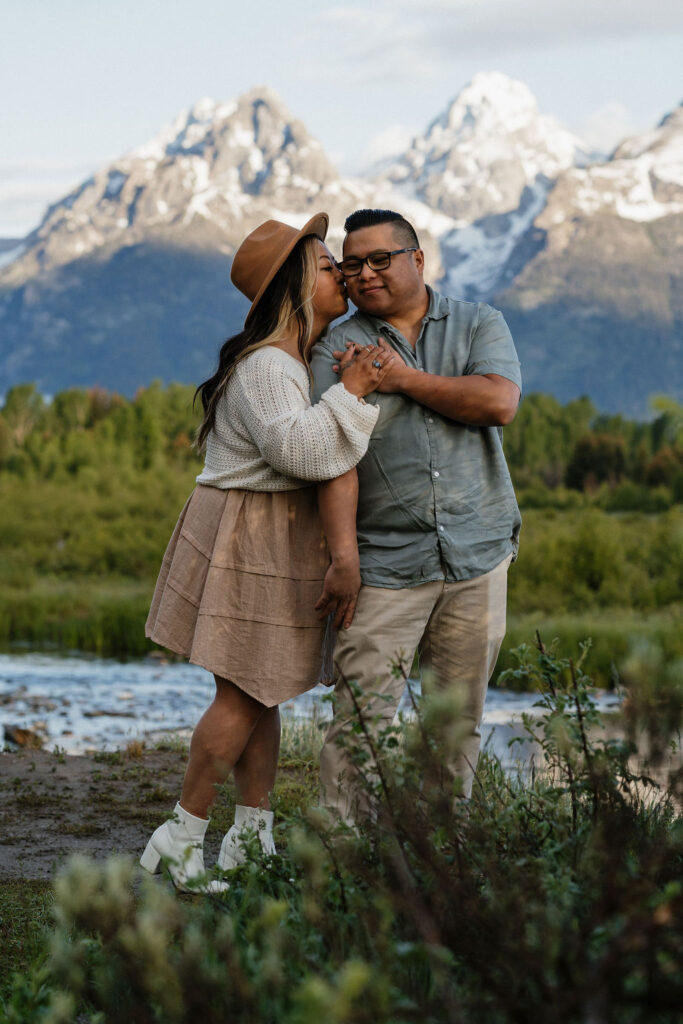 fiance kissing his fiance on the cheek 