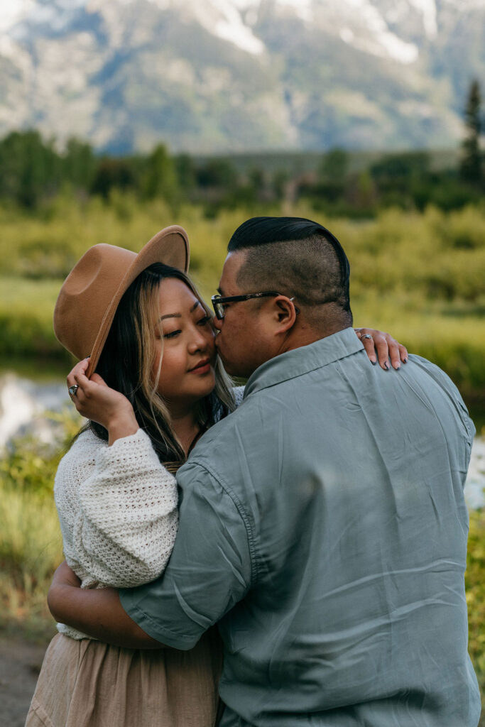 fiance kissing his fiance on the cheek