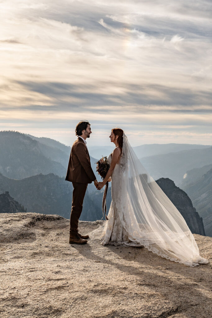 couple looking at each other holding hands 