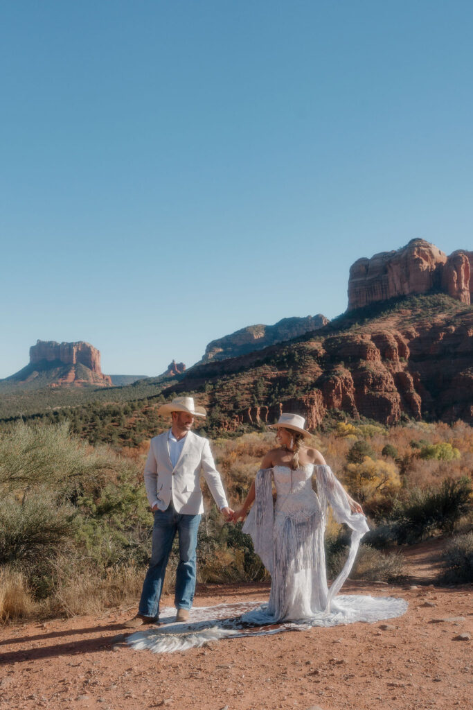 elope in sedona couple holding hands during their photoshoot