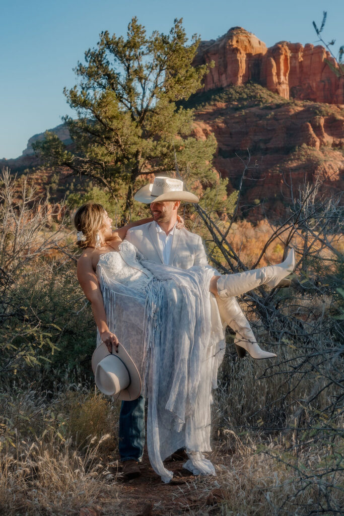 groom carrying the bride