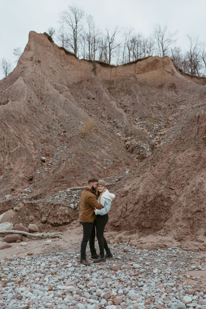 couple hugging at their engagement session - engagement outfits