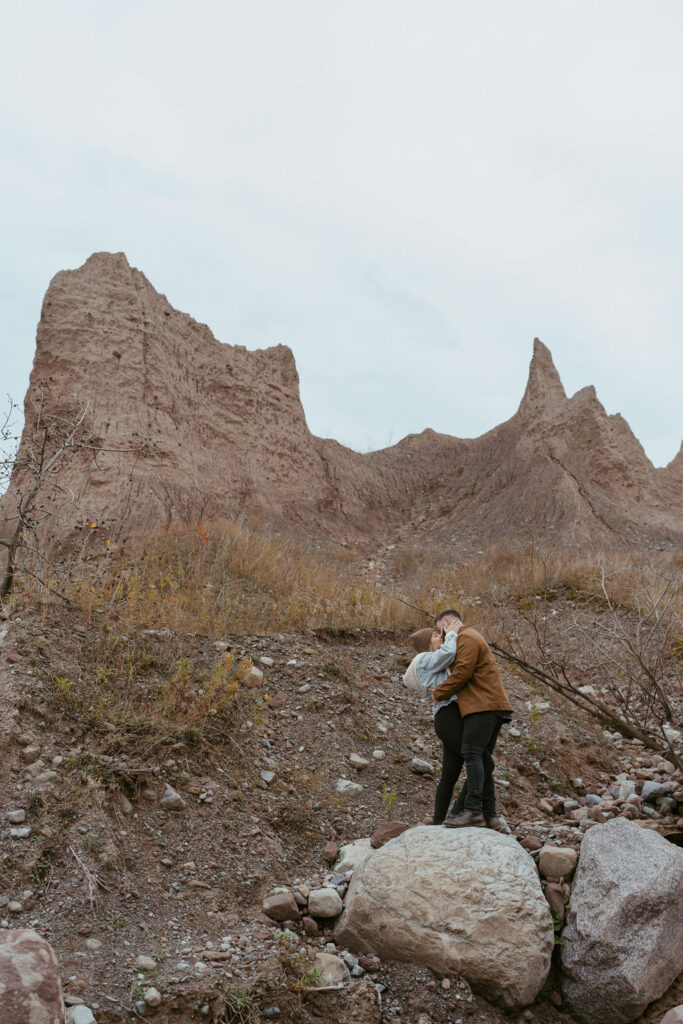 adventurous couple hugging 