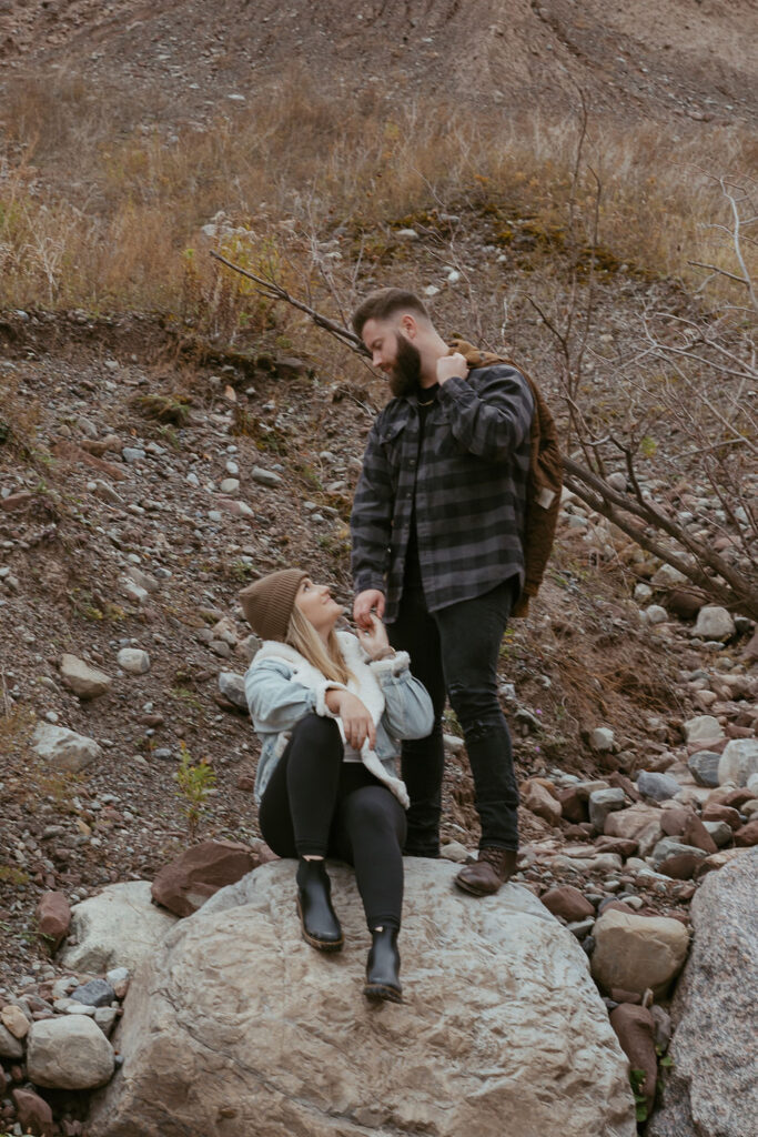 newly engaged couple looking at each other 