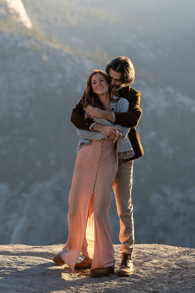 couple hugging during their sunrise engagement session 