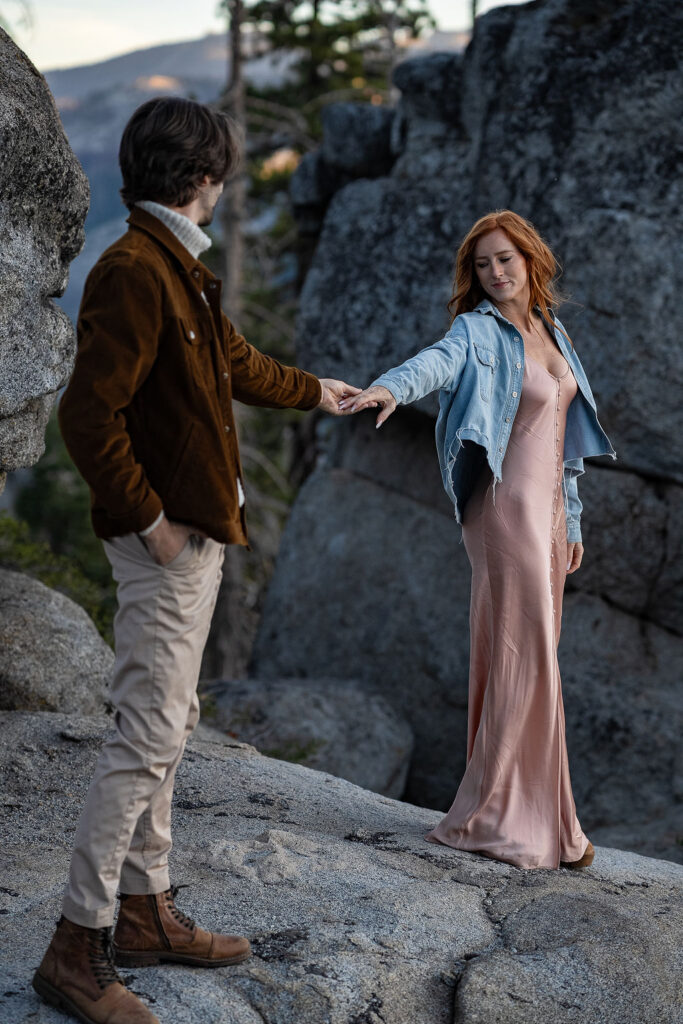 cute couple looking at each other during their sunrise engagement session 