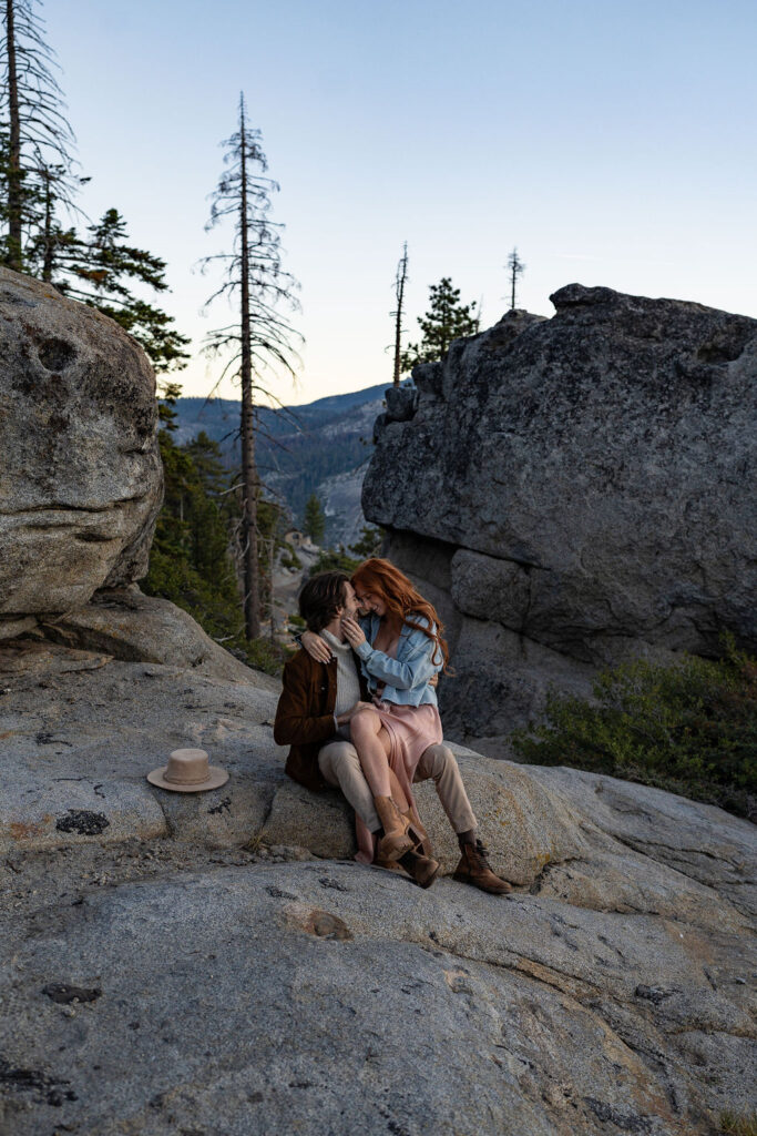 couple sitting at yosemite national park during their sunrise engagement session 