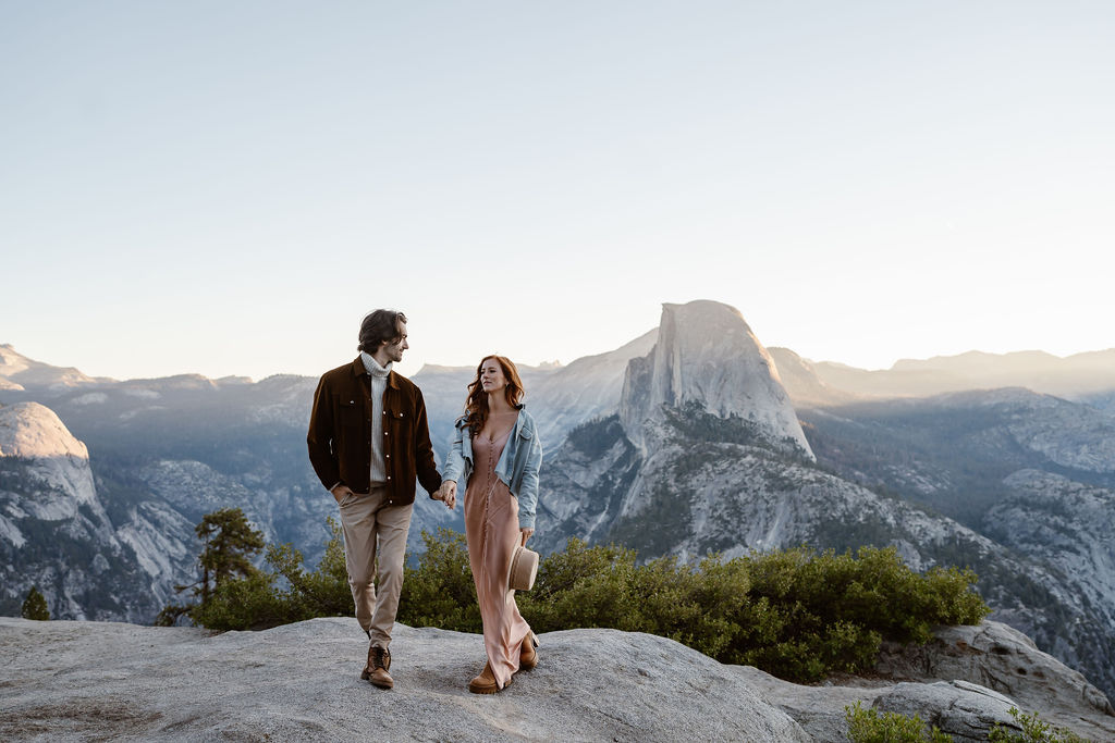 couple walking around yosemite national park during their sunrise engagement session