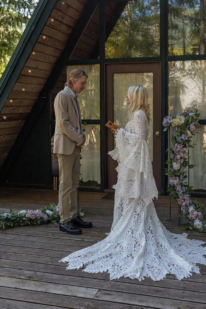 bride and groom reading their vows