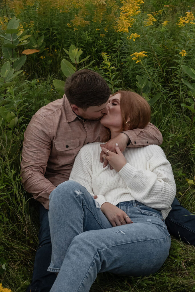 newly engaged couple kissing 