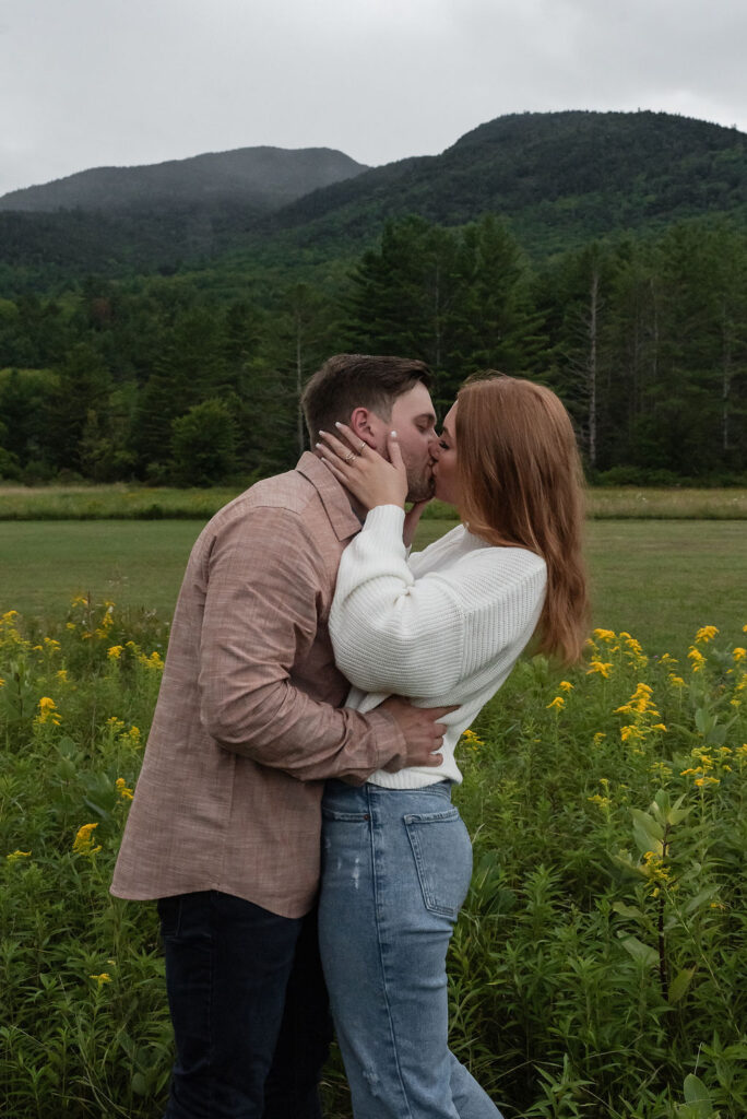 newly engaged couple kissing 