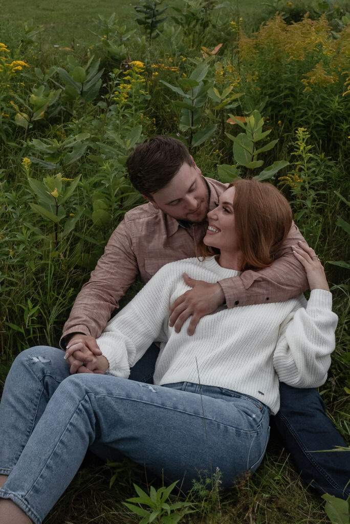 couple sitting in a field 