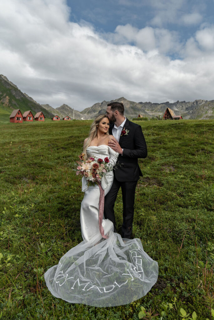 groom kissing the bride on the forehead 