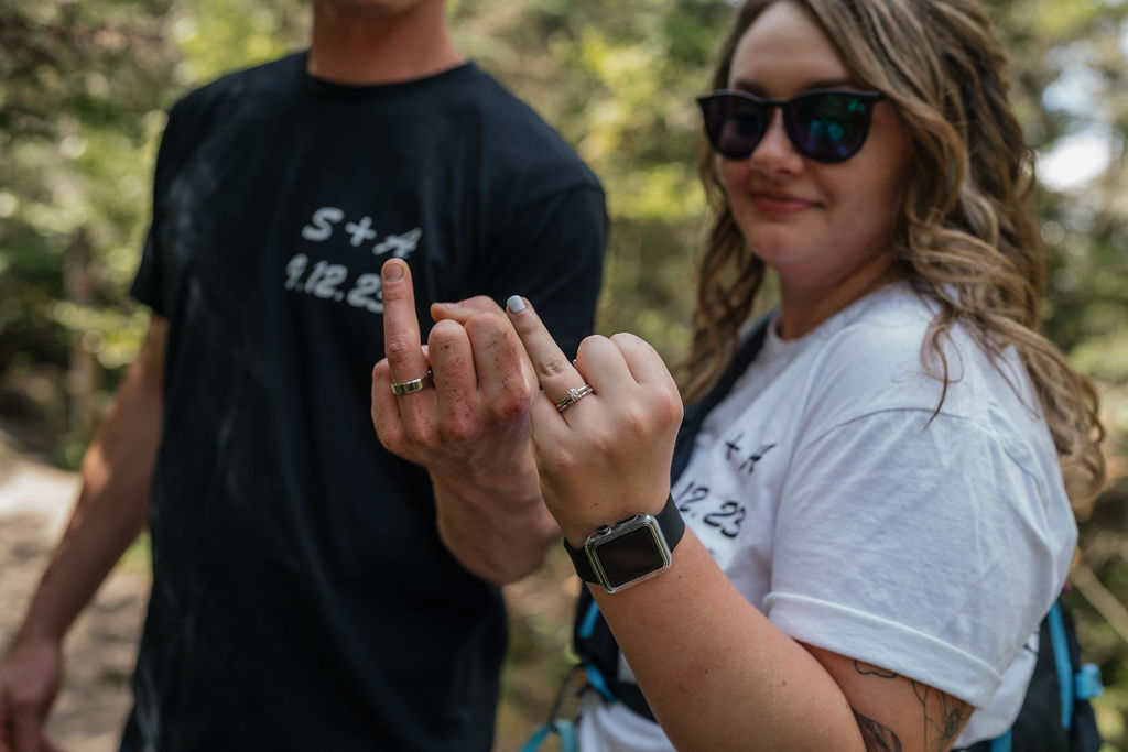 bride and groom showing their wedding rings