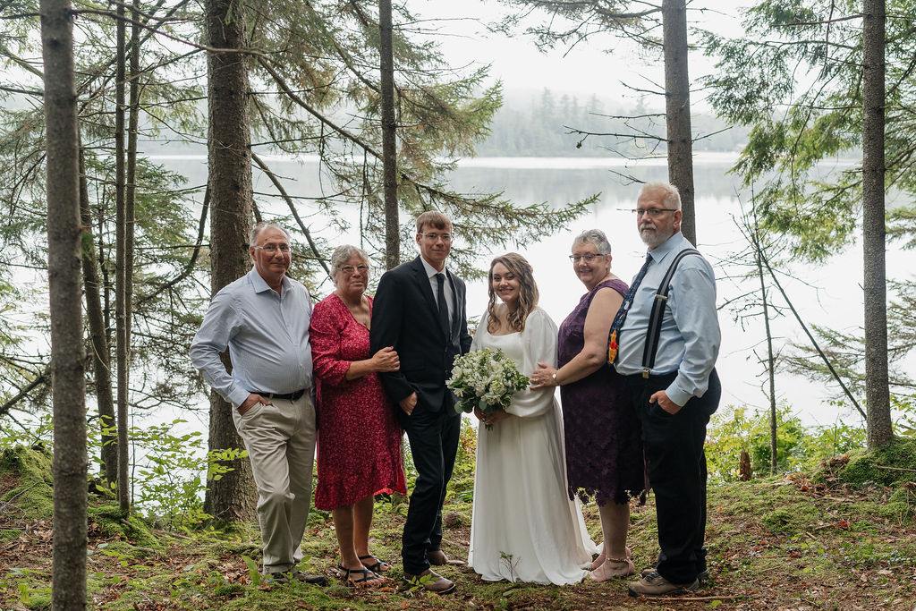 portrait of the bride and groom with their family 