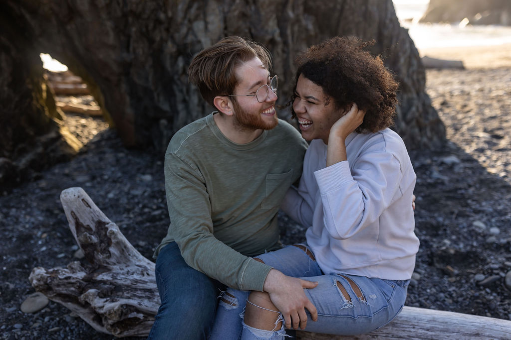 couple laughing during their photoshoot at the beach