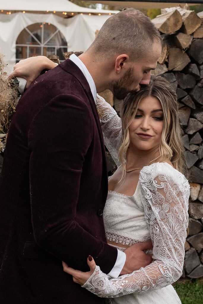 groom kissing the bride on the forehead 