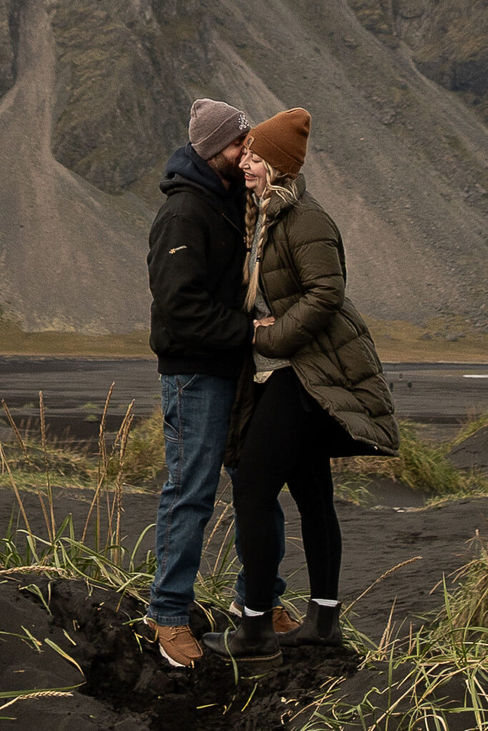 fiance kissing his fiance on the cheek during their photoshoot in iceland 