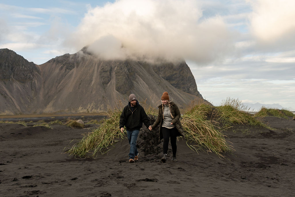 couple holding hands at their photoshoot in Stokksnes