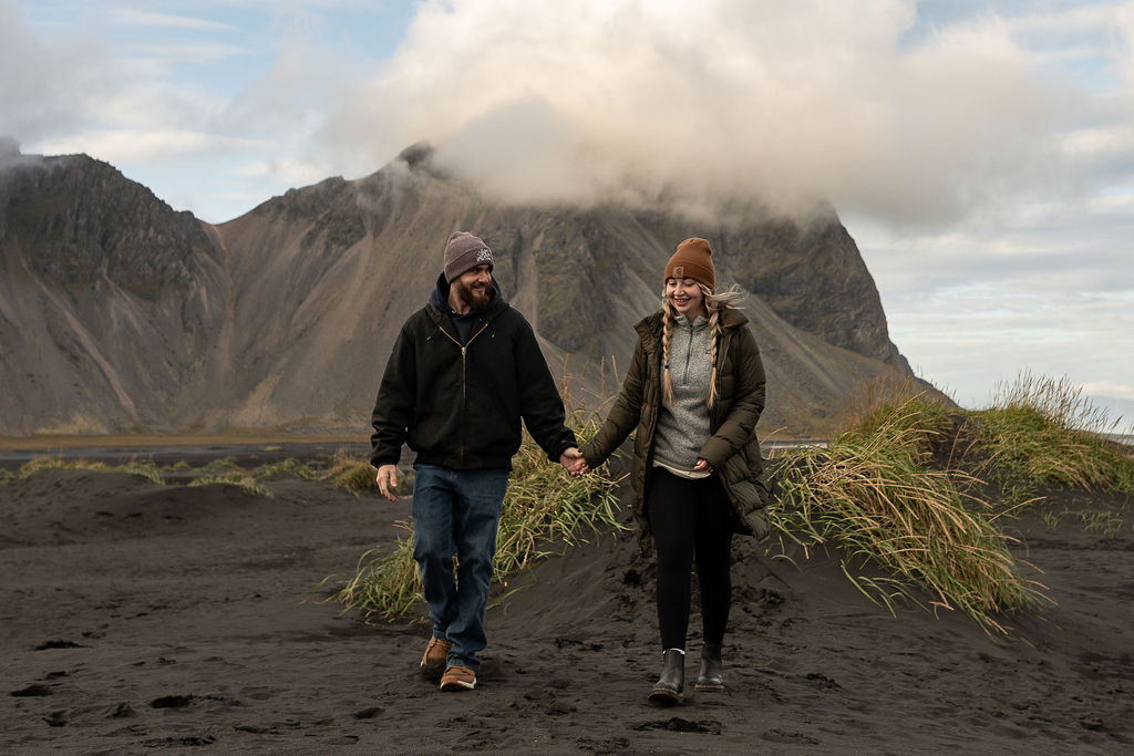 couple walking around stokksnes during their photoshoot - elope in iceland 