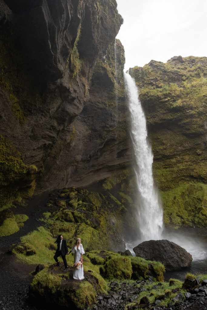 couple kissing with an amazing waterfall as their backdrop