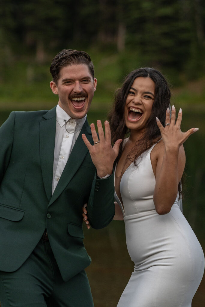 happy couple showing their wedding rings 