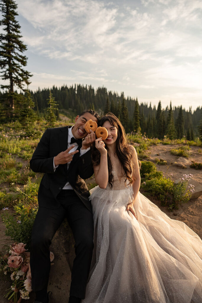 couple eating donuts at their elopement 