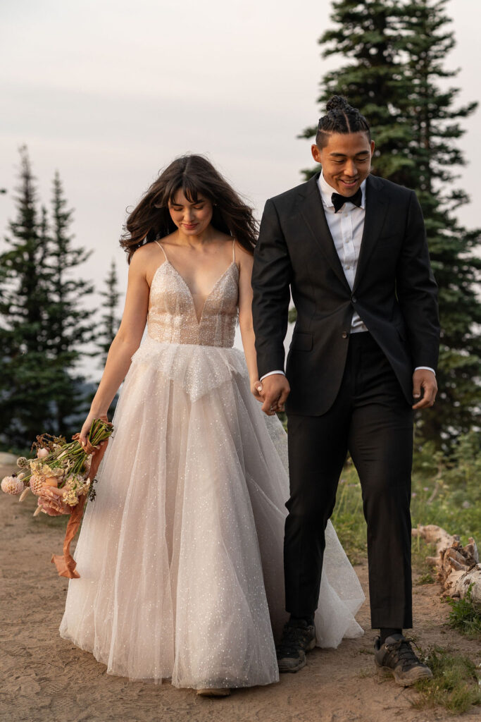 bride and groom walking around mt. rainier 