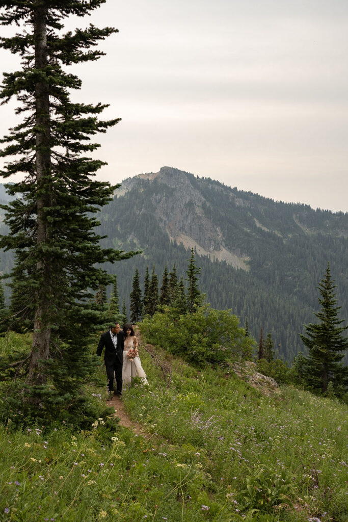 bride and groom walking around mt. rainier national park