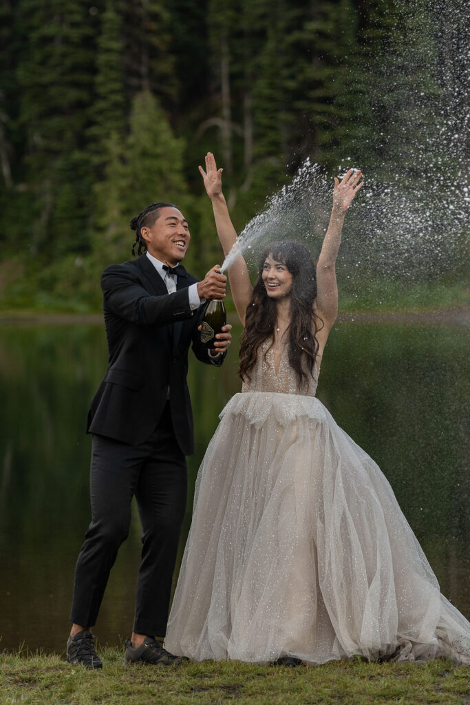 newlyweds opening a bottle of champagne 