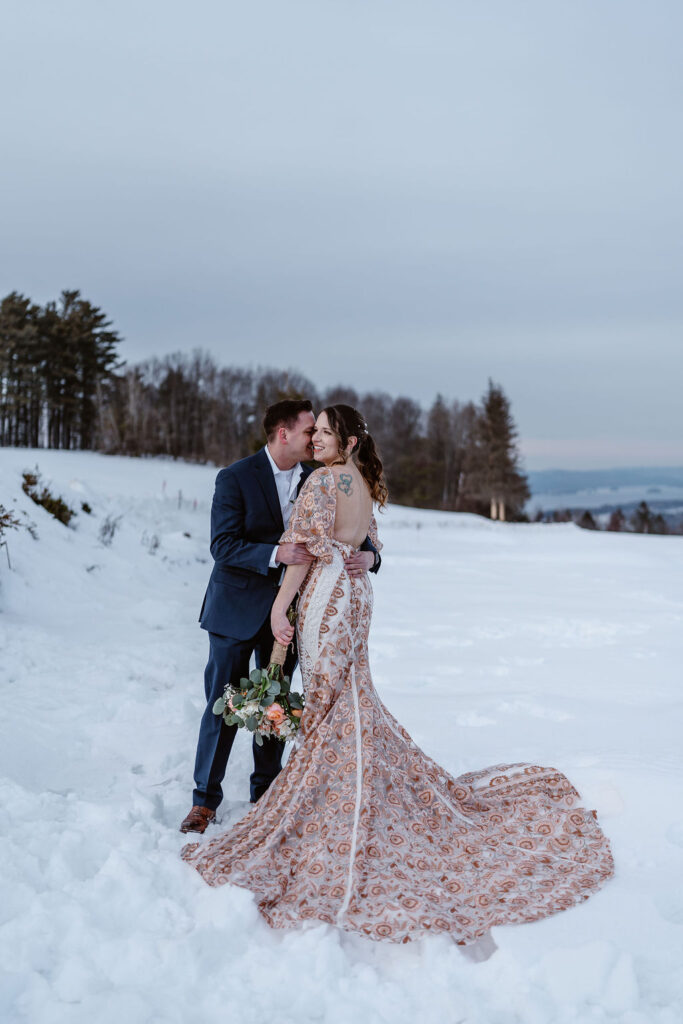 groom kissing the bride on the cheek