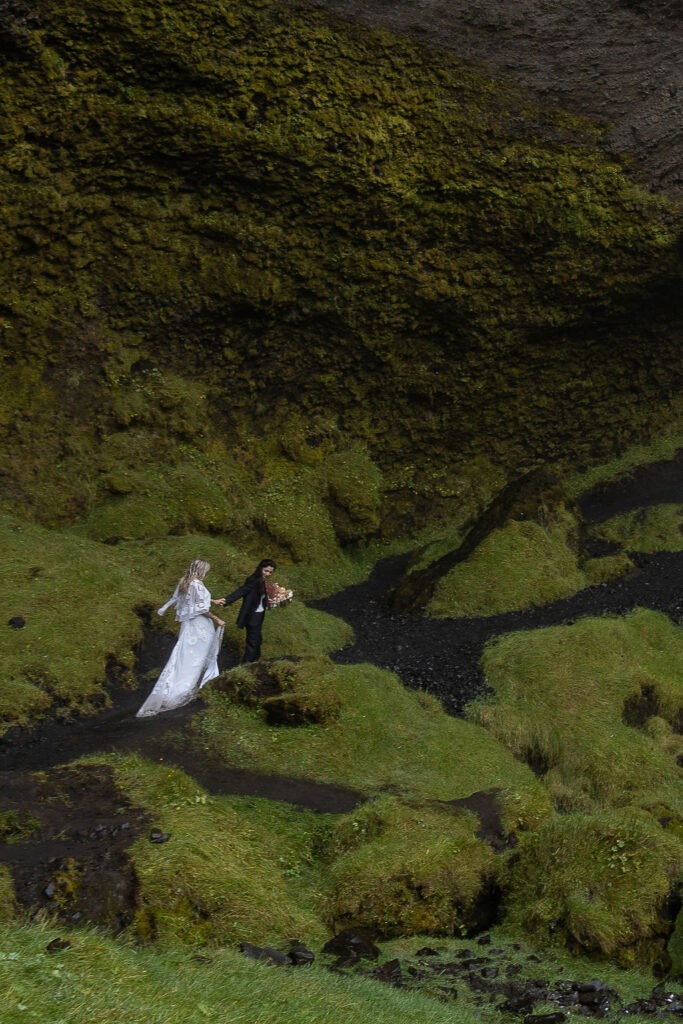 couple walking around kvernufoss during their photoshoot