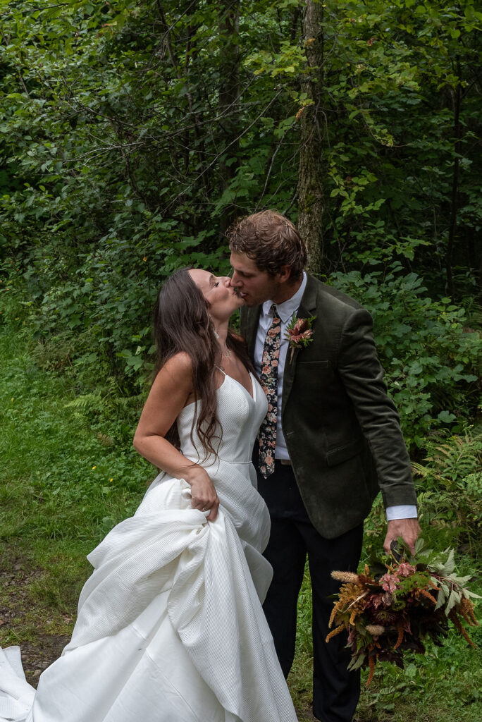 portrait of the bride and groom kissing before their ceremony in lake placid