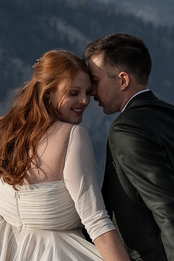 groom kissing the bride on the cheek