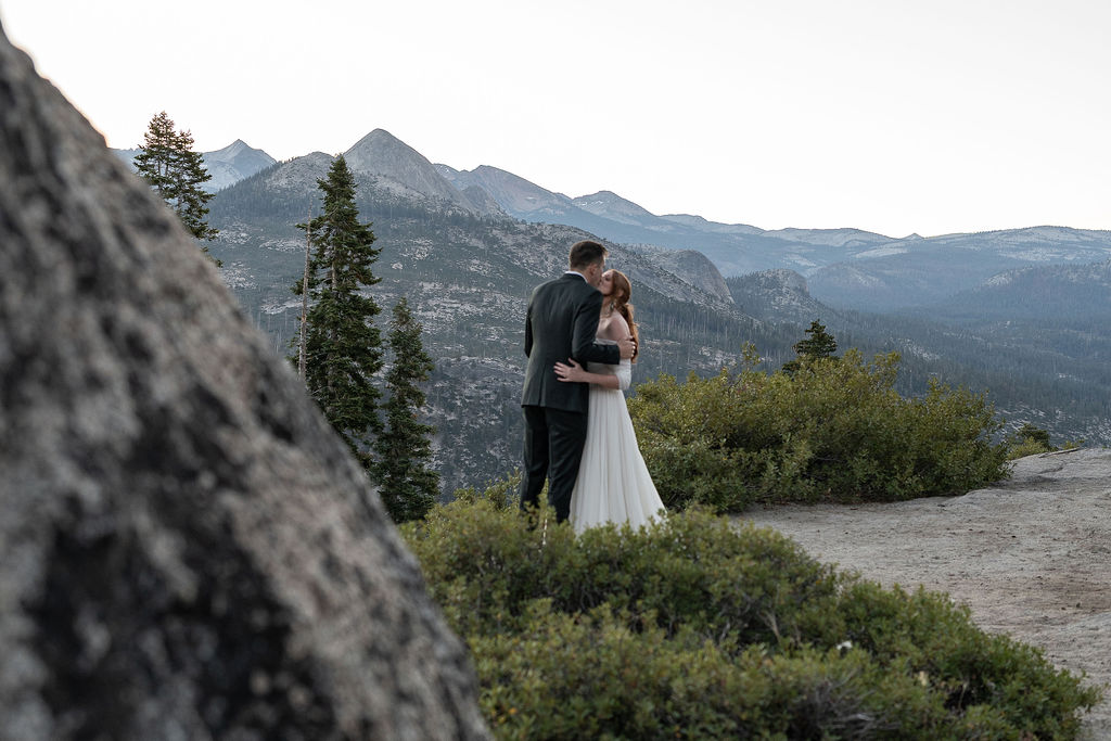 Picture of the bride and groom, kissing before their ceremony