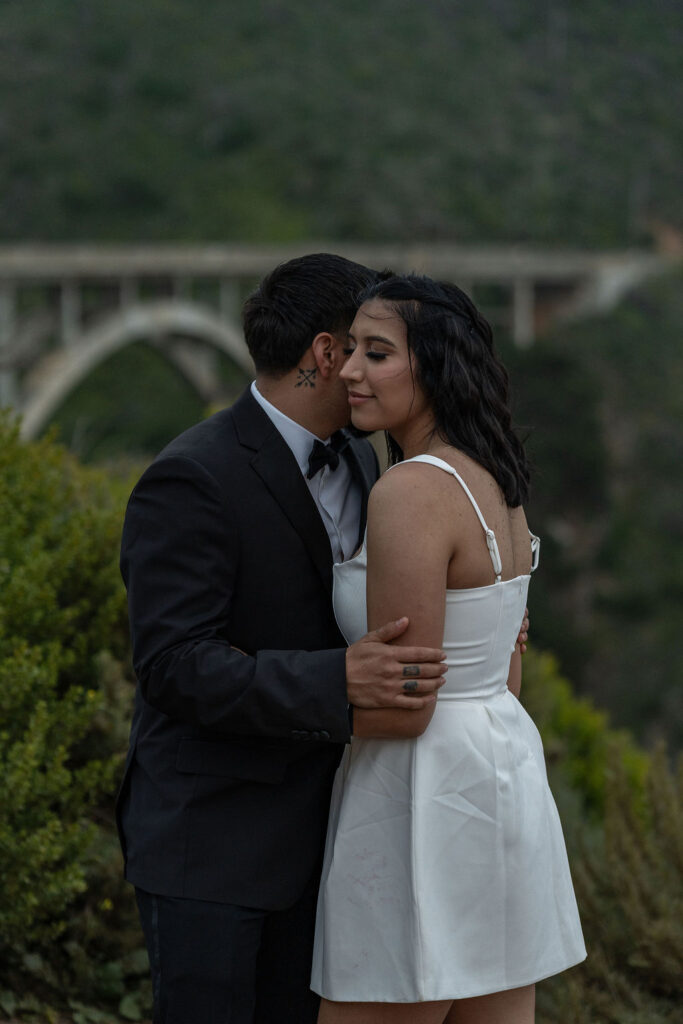 groom kissing the bride on the cheek