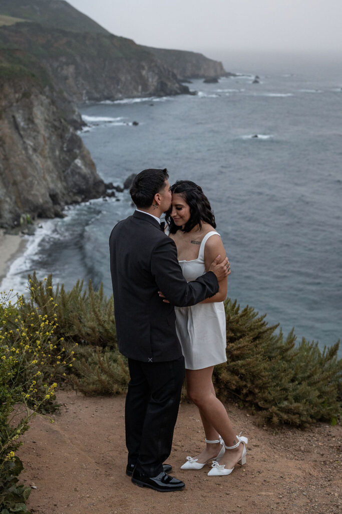 groom kissing the bride on the forehead