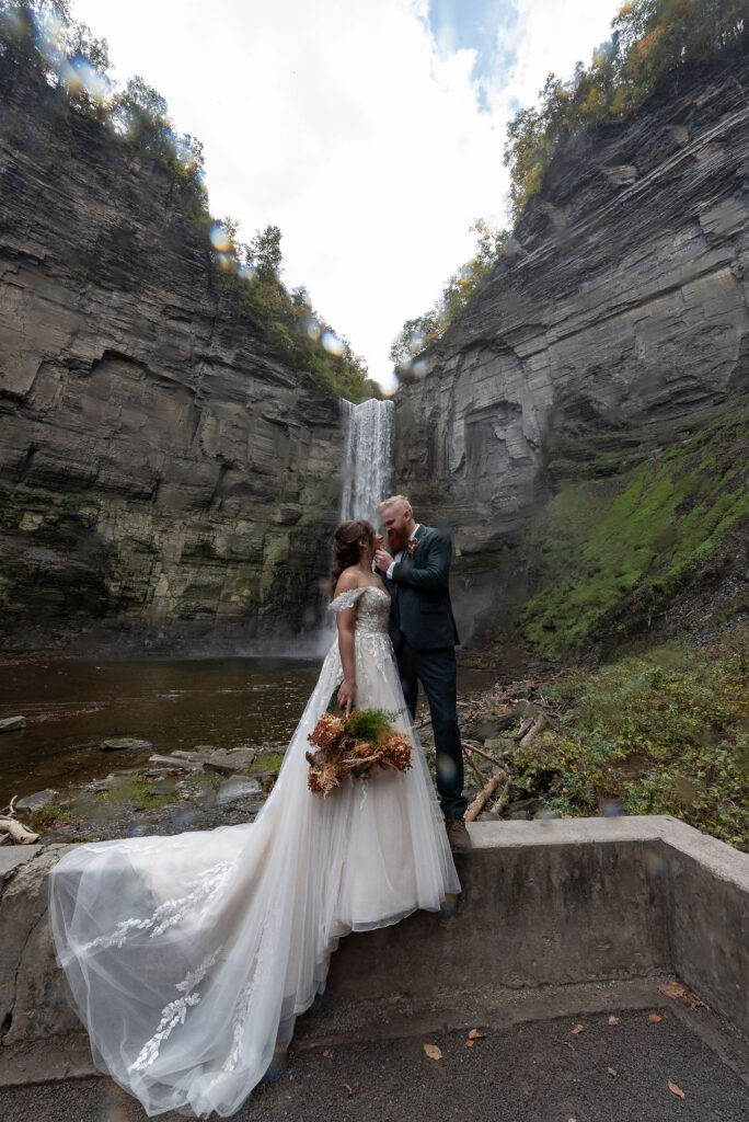 cute picture of the bride and groom kissing during their photoshoot