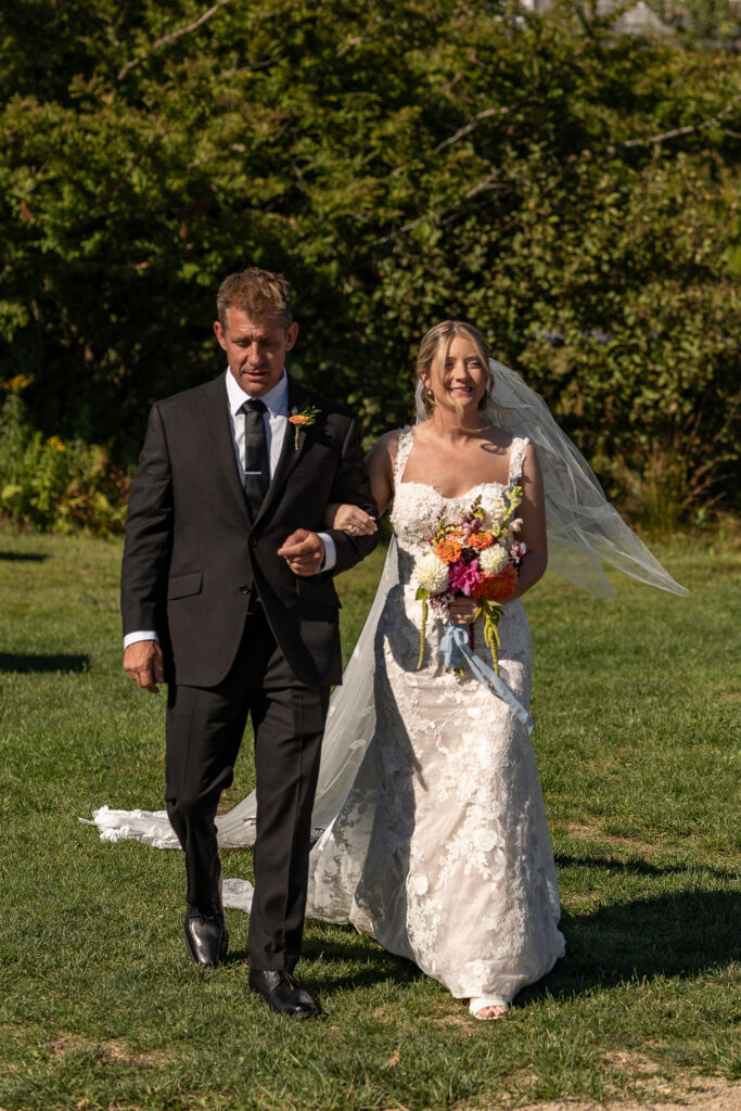 stunning picture of the bride walking dow the aisle